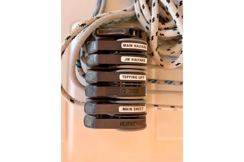 Slide: The Image of Close-up of labeled rope clutches on a 2006 Beneteau Oceanis 523 sailboat. - 16