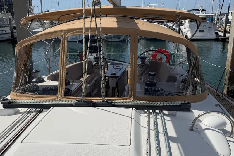 Slide: The Image of 2006 Beneteau Oceanis 523 sailboat with tan canopy docked at marina. - 18