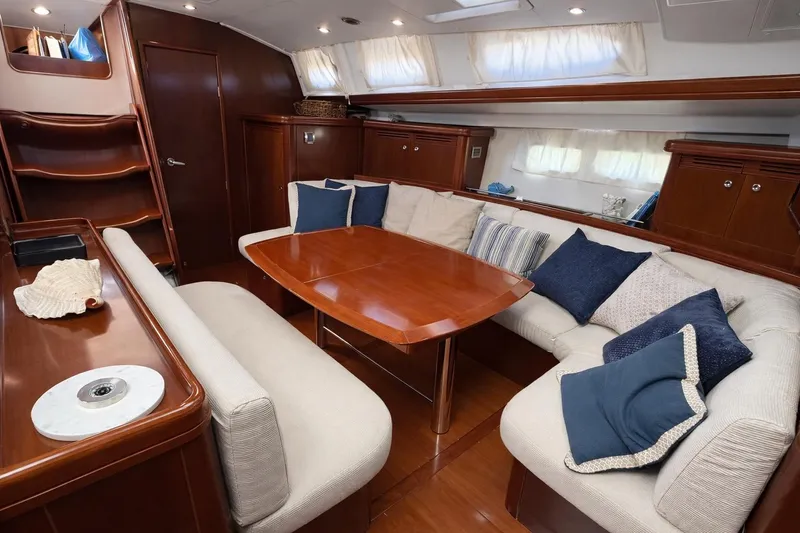 Slide: The Image of Luxurious interior of 2006 Beneteau Oceanis 523 yacht with elegant seating and wooden table. - 2