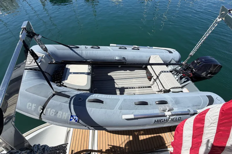 Slide: The Image of Inflatable dinghy on Beneteau Oceanis 523 yacht, 2006 model, docked on calm water. - 22