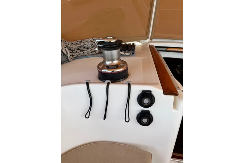 Slide: The Image of Deck equipment on a 2006 Beneteau Oceanis 523 sailboat, featuring winch and rope cleats. - 24