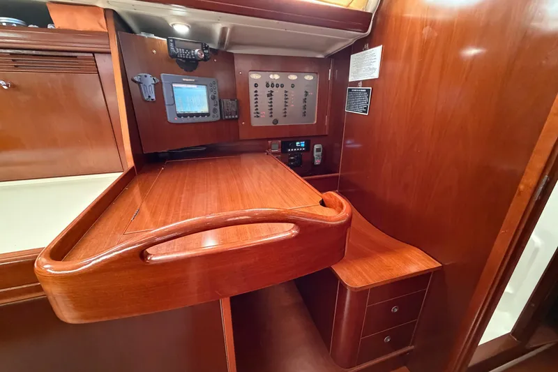 Slide: The Image of Navigation station on 2006 Beneteau Oceanis 523 yacht with wooden finish and control panel. - 30