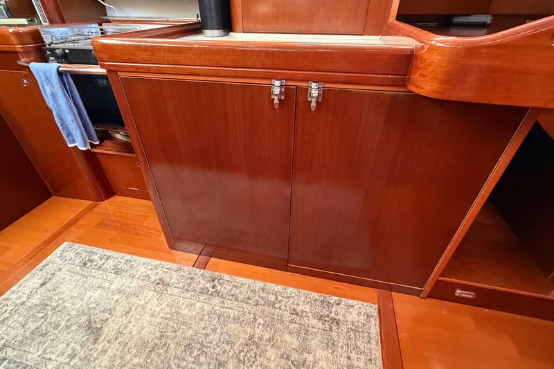 Slide: The Image of Wooden cabinetry in the galley of a 2006 Beneteau Oceanis 523 sailboat. - 34