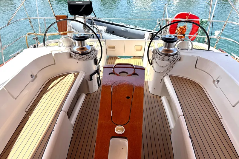 Slide: The Image of Cockpit of 2006 Beneteau Oceanis 523 sailboat with dual steering wheels and teak flooring. - 4