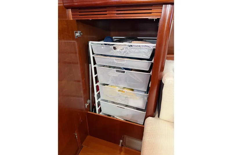 Slide: The Image of Storage drawers inside a 2006 Beneteau Oceanis 523 yacht, featuring organized compartments. - 41
