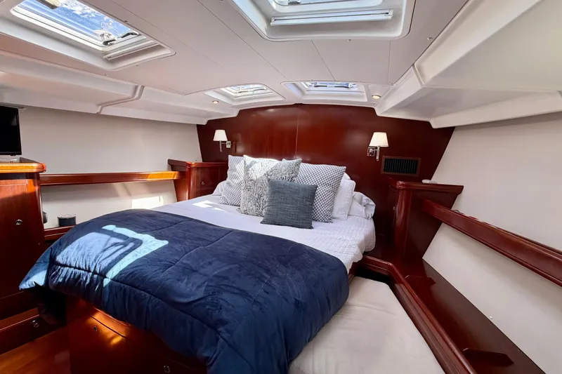 Slide: The Image of Luxurious cabin interior of 2006 Beneteau Oceanis 523 yacht with skylights and cozy bedding. - 53