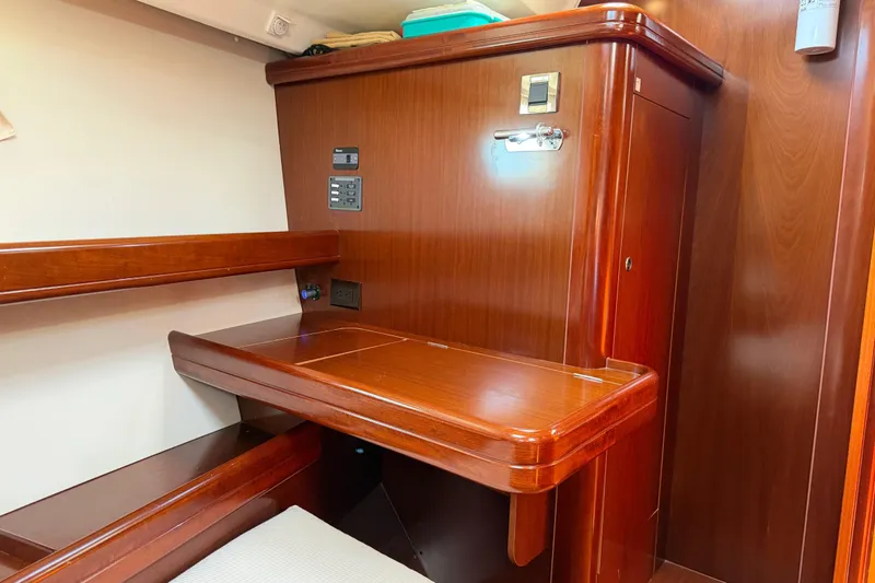 Slide: The Image of Interior of 2006 Beneteau Oceanis 523 yacht with wooden desk and paneling. - 56