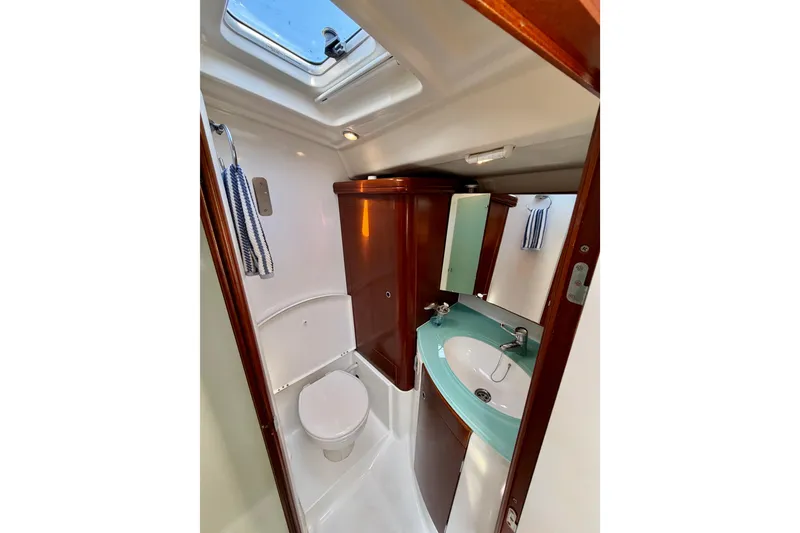 Slide: The Image of Bathroom interior of 2006 Beneteau Oceanis 523 yacht, featuring sink and toilet. - 59