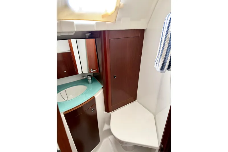 Slide: The Image of Bathroom interior of 2006 Beneteau Oceanis 523 yacht with modern sink and wooden cabinetry. - 65