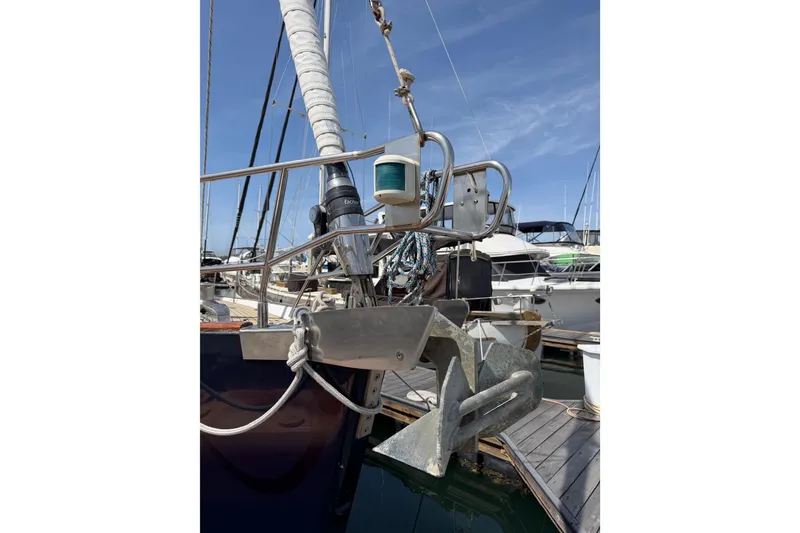 Slide: The Image of 2006 Beneteau Oceanis 523 sailboat anchor and bow detail at marina. - 76