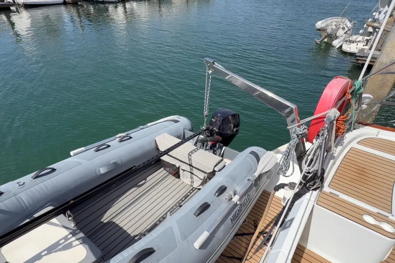 Slide: The Image of Beneteau Oceanis 523 sailboat with dinghy and outboard motor, docked in marina, 2006 model. - 78