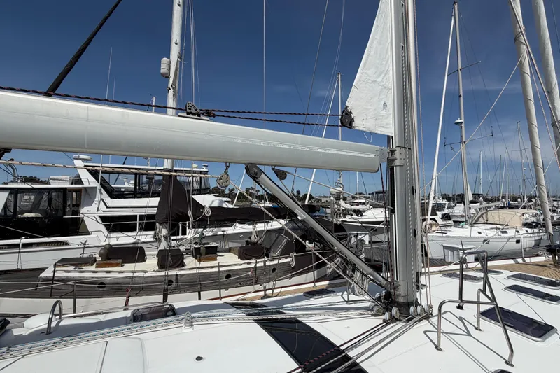 Slide: The Image of 2006 Beneteau Oceanis 523 sailboat docked in a marina under clear blue skies. - 80