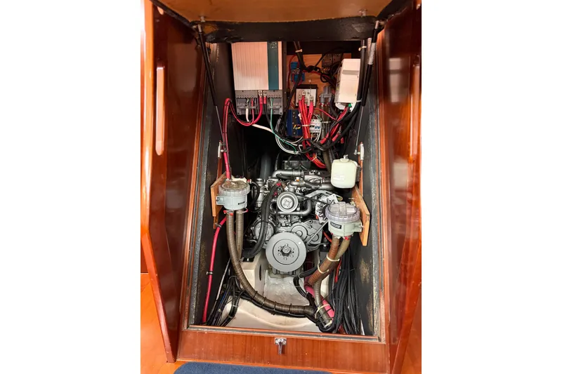 Slide: The Image of Engine compartment of a 2006 Beneteau Oceanis 523 sailboat, showcasing mechanical components. - 83
