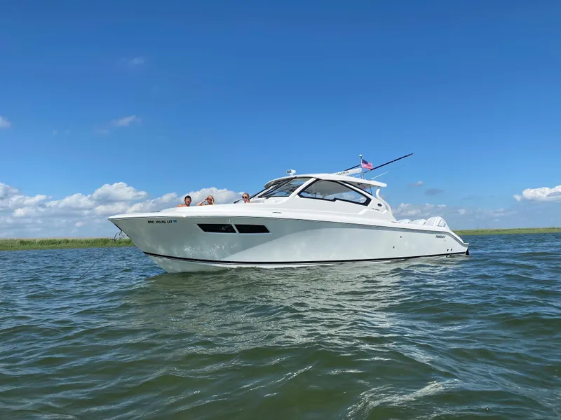 The Image of 2022 Pursuit DC 365 boat cruising on a sunny day. - 0