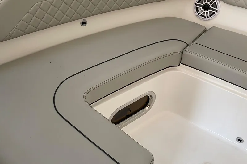 Slide: The Image of 2022 Pursuit DC 365 boat interior seating and storage compartment. - 9