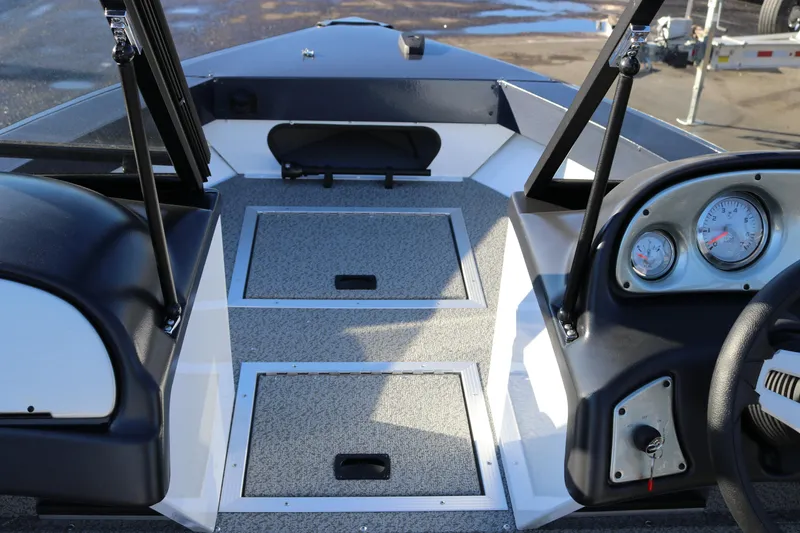 Slide: The Image of 2026 Smoker Craft Osprey 162 boat interior with dashboard and storage compartments. - 10