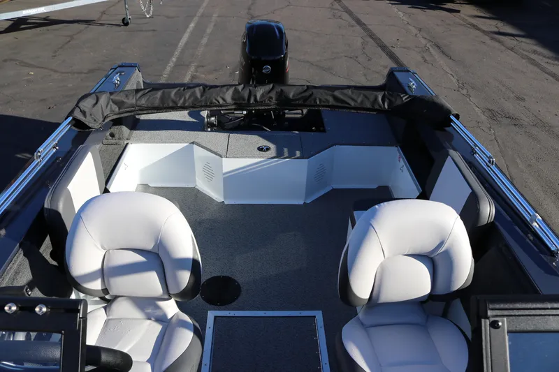 Slide: The Image of 2026 Smoker Craft Osprey 162 boat interior with two white seats and motor. - 20