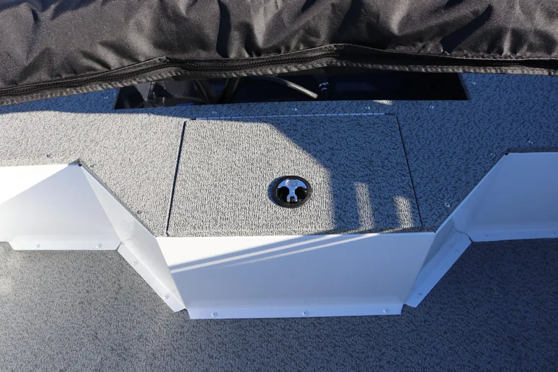 Slide: The Image of 2026 Smoker Craft Osprey 162 boat deck with storage compartment and textured surface. - 22