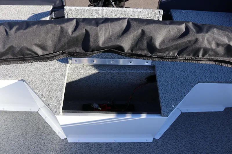 Slide: The Image of 2026 Smoker Craft Osprey 162 boat interior storage compartment with black cover. - 23