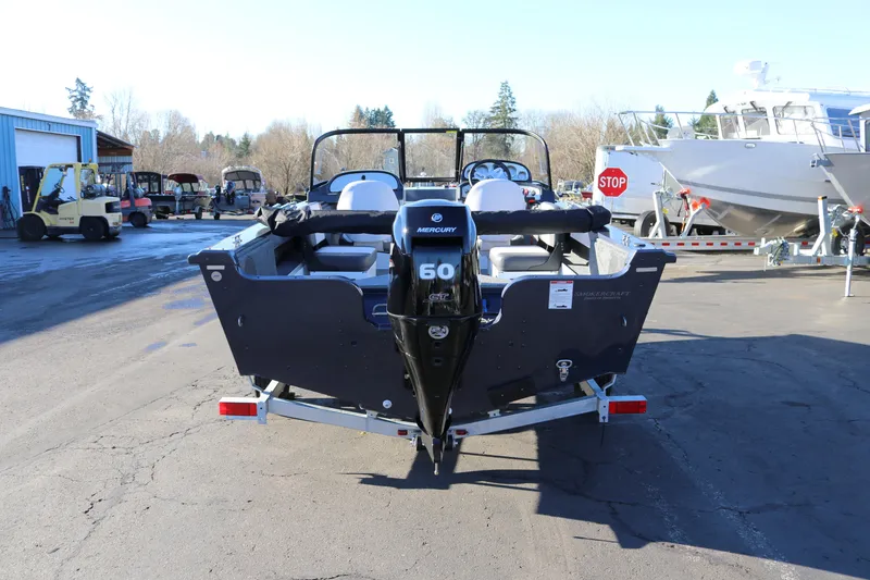 Slide: The Image of 2026 Smoker Craft Osprey 162 boat with Mercury 60 engine, parked outdoors. - 4