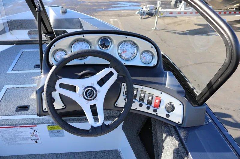 Slide: The Image of 2026 Smoker Craft Osprey 162 boat dashboard with steering wheel and gauges. - 7