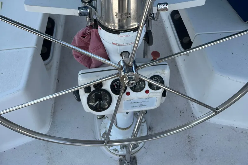 Slide: The Image of Steering wheel and controls of a 2000 Catalina 380 sailboat cockpit. - 13