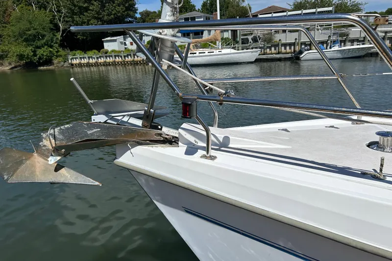 Slide: The Image of Catalina 380 sailboat bow with anchor, docked in a serene marina setting. - 16