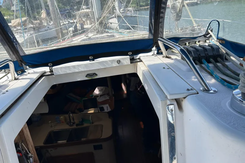 Slide: The Image of Cockpit view of a 2000 Catalina 380 sailboat with visible interior and rigging. - 19