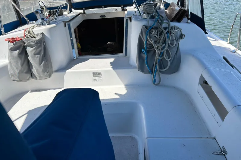Slide: The Image of Cockpit of a 2000 Catalina 380 sailboat with ropes and storage bags. - 20