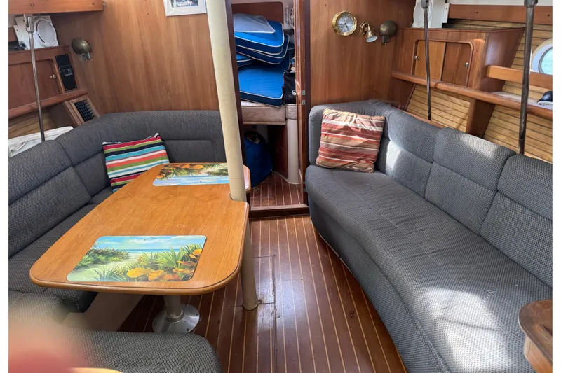 Slide: The Image of Interior of 2000 Catalina 380 sailboat with cozy seating and wooden table. - 23