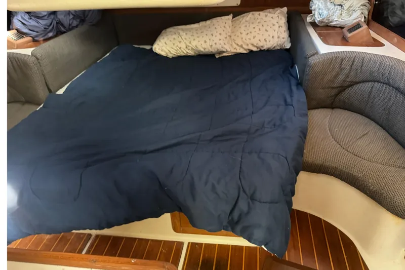 Slide: The Image of Interior cabin of a 2000 Catalina 380 sailboat with a cozy bed setup. - 25