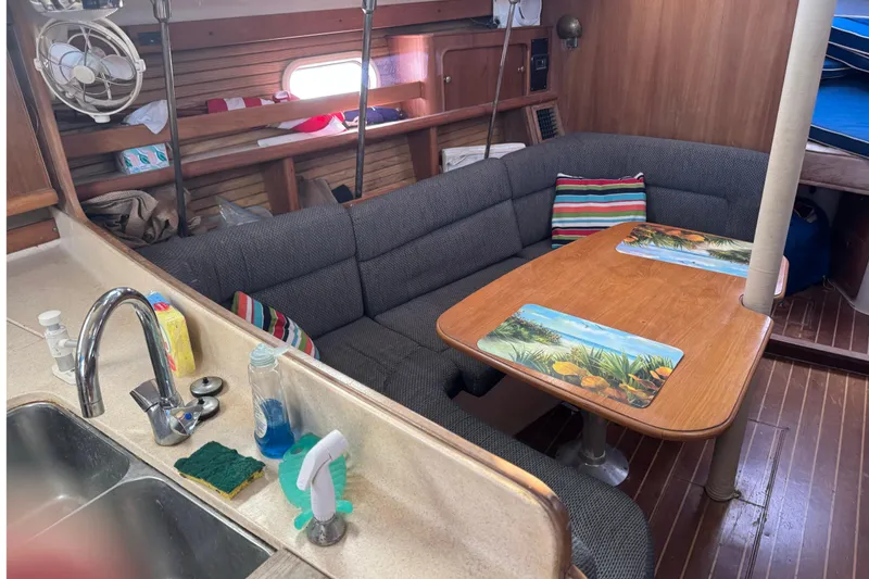 Slide: The Image of Interior of 2000 Catalina 380 sailboat with cozy seating and dining area. - 30