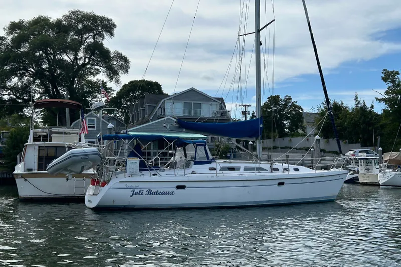 Slide: The Image of Catalina 380 sailboat from 2000 docked in a marina, named "Joli Bateaux." - 33