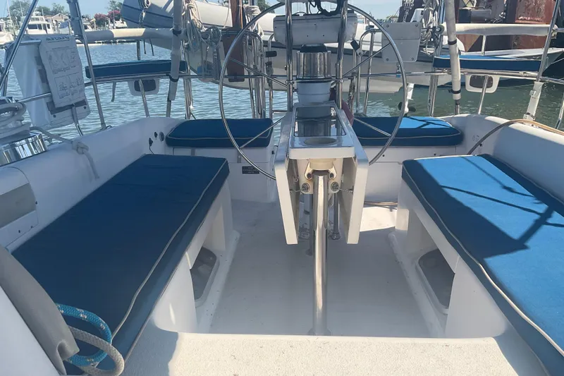 Slide: The Image of Cockpit of 2000 Catalina 380 sailboat with blue cushioned seating and steering wheel. - 5