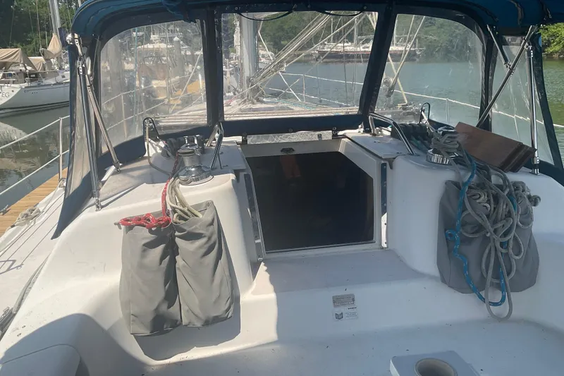 Slide: The Image of 2000 Catalina 380 sailboat cockpit with ropes and winches, docked in a marina. - 8