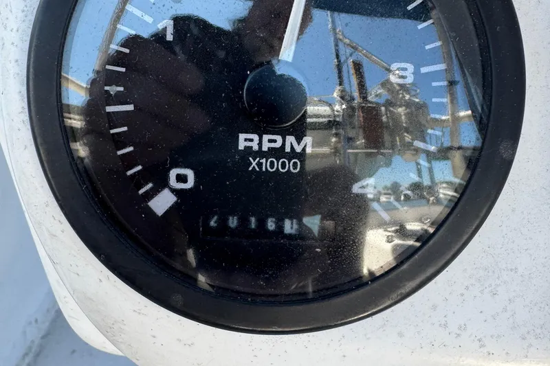 Slide: The Image of Close-up of a Catalina 380 tachometer, showing RPM gauge with reflections. - 9