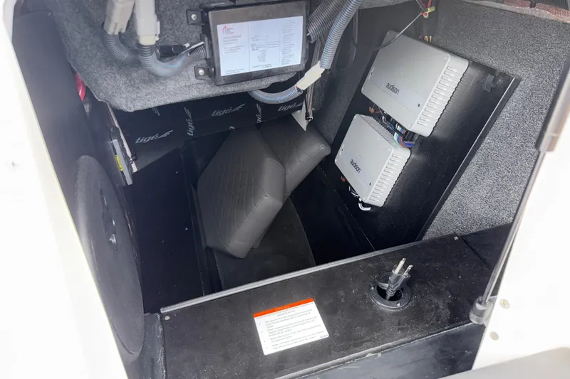 Slide: The Image of 2023 Tigé 23ZX boat interior showing audio system components and wiring. - 11