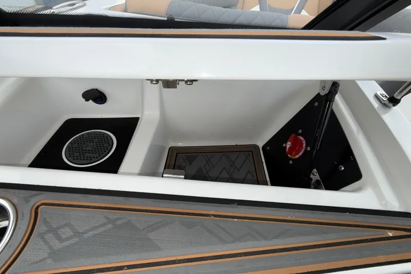 Slide: The Image of 2023 Tigé 23ZX boat storage compartment with speaker and control panel. - 12