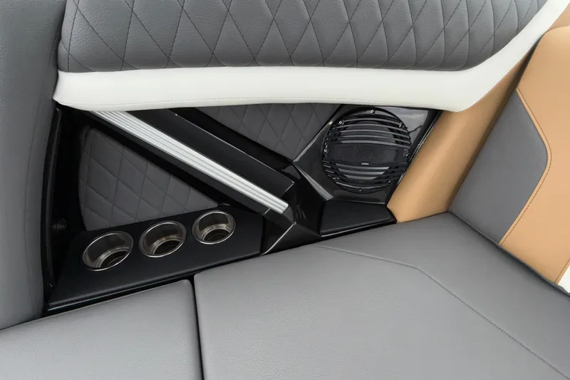 Slide: The Image of 2023 Tigé 23ZX interior detail with quilted upholstery, speaker, and cup holders. - 13