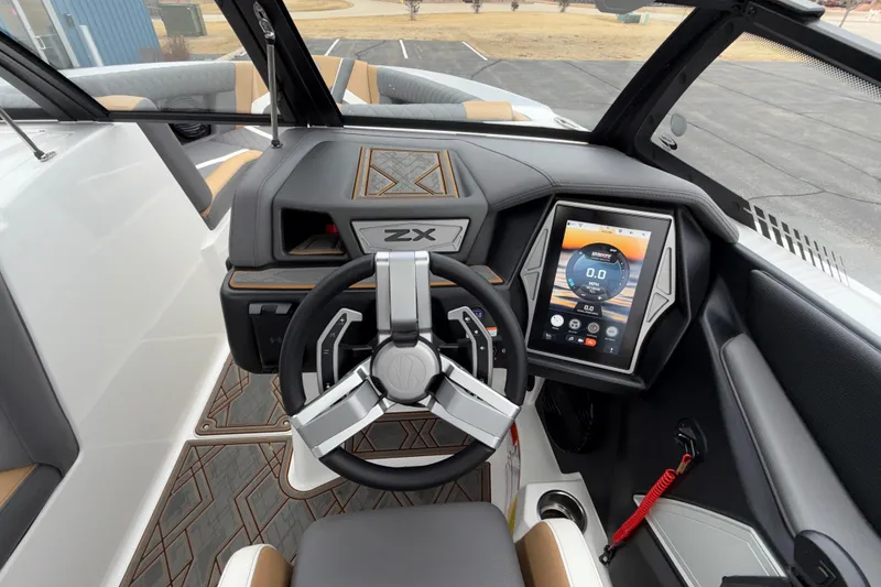 Slide: The Image of 2023 Tigé 23ZX boat dashboard with touchscreen display and modern steering wheel. - 14