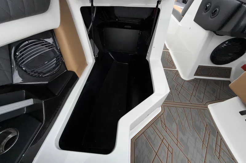 Slide: The Image of 2023 Tigé 23ZX boat interior storage compartment with modern design and speaker system. - 24