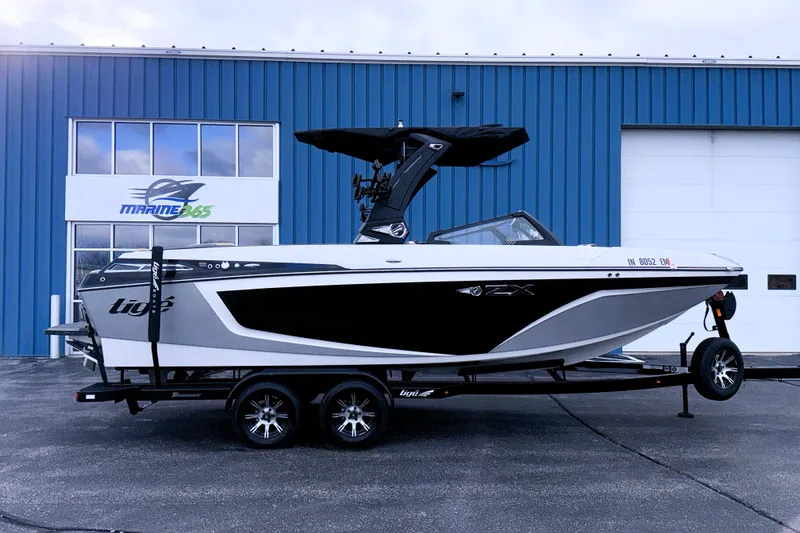 Slide: The Image of 2023 Tigé 23ZX boat on trailer outside Marine365 building. - 6