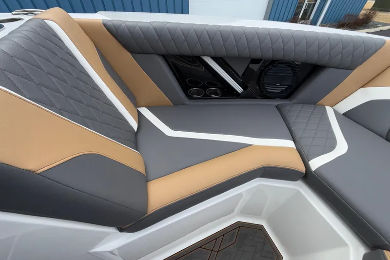 Slide: The Image of 2023 Tigé 23ZX boat interior with stylish gray and tan seating, featuring quilted design. - 8