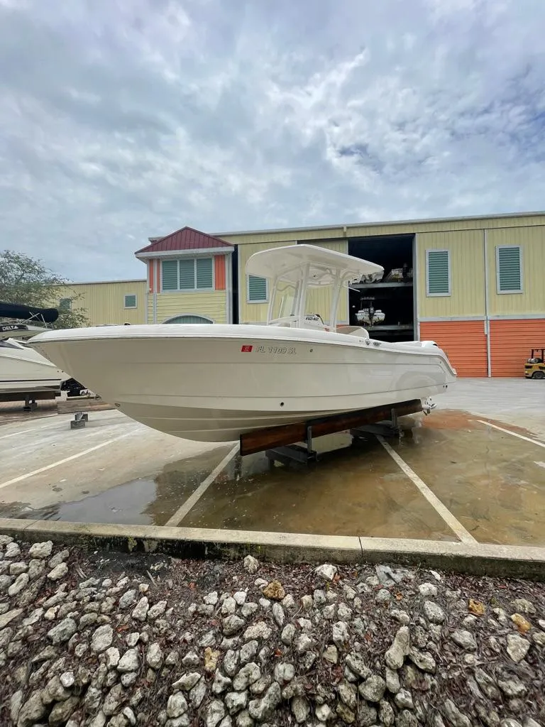 The Image of 2019 Robalo R242 Center Console boat on a trailer outside a storage facility. - 0