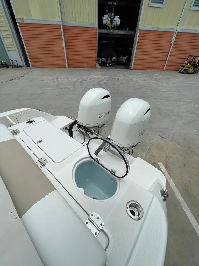 Slide: The Image of 2019 Robalo R242 Center Console boat with twin outboard engines. - 11