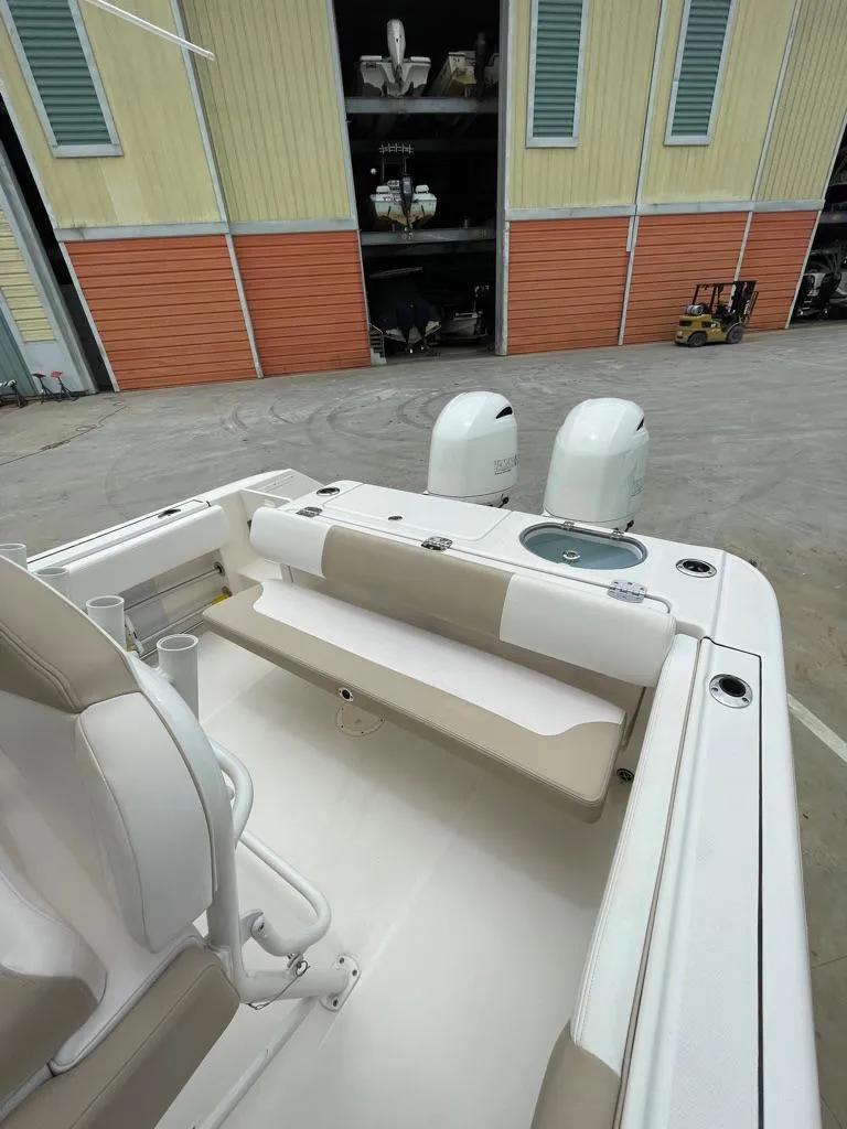 Slide: The Image of 2019 Robalo R242 Center Console boat with twin engines and seating. - 12