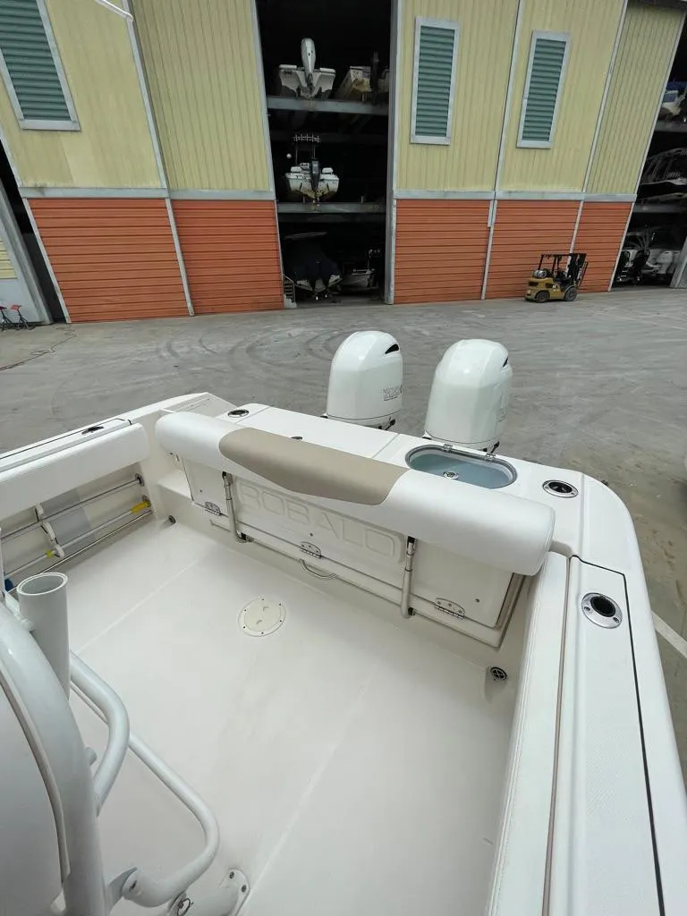 Slide: The Image of 2019 Robalo R242 Center Console boat with dual outboard motors. - 13