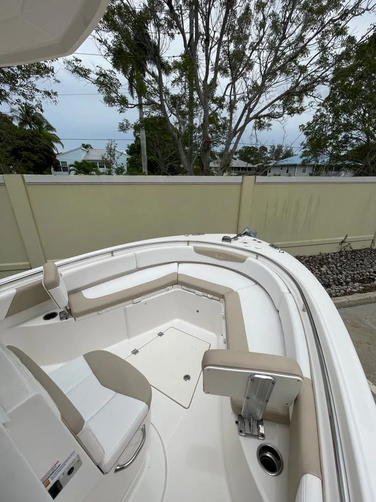 Slide: The Image of 2019 Robalo R242 Center Console boat with beige and white seating. - 16