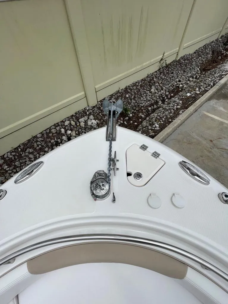 Slide: The Image of 2019 Robalo R242 Center Console boat bow with anchor and storage compartments. - 21