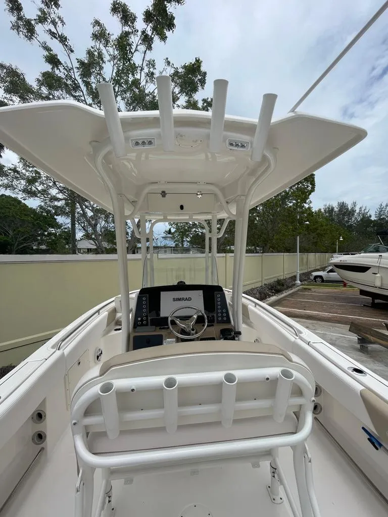 Slide: The Image of 2019 Robalo R242 Center Console boat with T-top and helm station. - 27